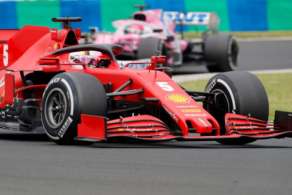 Ferrari's German driver Sebastian Vettel steers his car in front of Racing Point's Mexican driver Sergio Perez during the Formula One Hungarian Grand Prix race at the Hungaroring circuit in Mogyorod near Budapest, Hungary, on July 19, 2020. (Photo by Darko Bandic / POOL / AFP) (Photo by DARKO BANDIC/POOL/AFP via Getty Images)