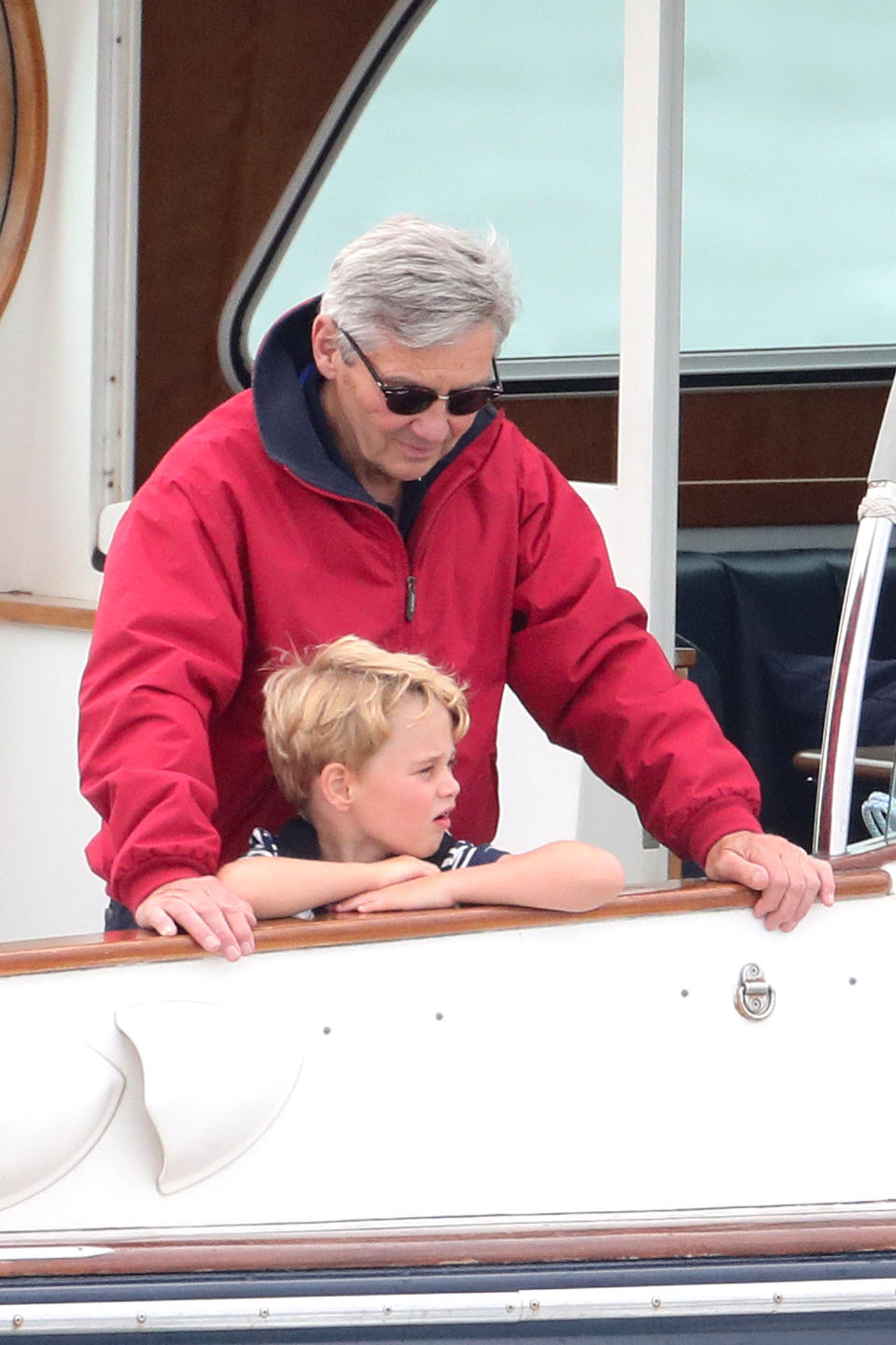 COWES, ENGLAND - AUGUST 08: Michael Middleton and Prince George watch the inaugural King’s Cup regatta hosted by the Duke and Duchess of Cambridge on August 08, 2019 in Cowes, England. Their Royal Highnesses hope that The King’s Cup will become an annual event bringing greater awareness to the wider benefits of sport, whilst also raising support and funds for Action on Addiction, Place2Be, the Anna Freud National Centre for Children and Families, The Royal Foundation, Child Bereavement UK, Centrepoint, London’s Air Ambulance Charity and Tusk. (Photo by Chris Jackson/Getty Images)