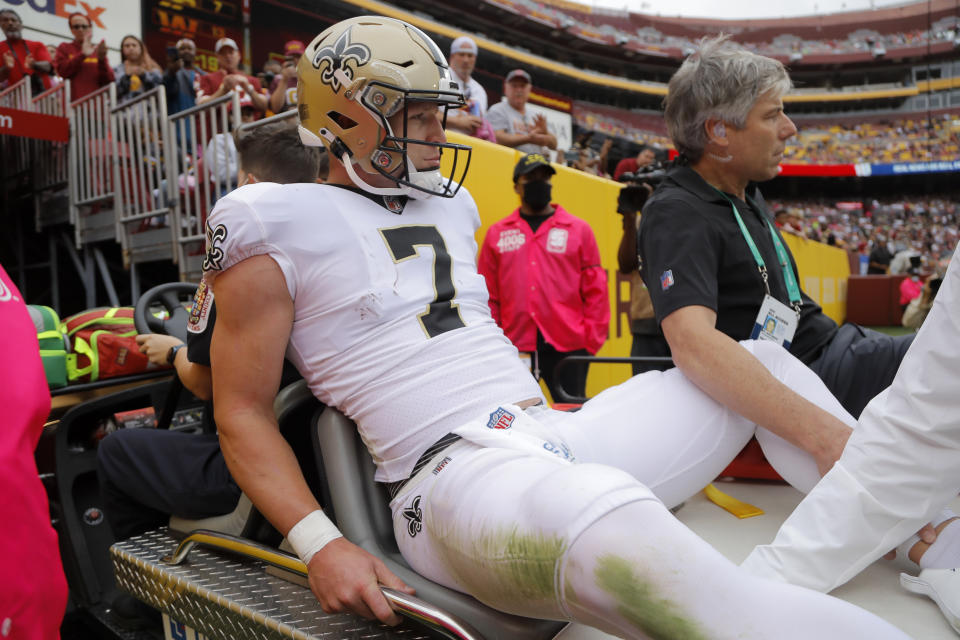 New Orleans Saints wide receiver Taysom Hill rides a cart off the field after being injured in the first half of an NFL football game against the Washington Football Team, Sunday, Oct. 10, 2021, in Landover, Md. (AP Photo/Julio Cortez)