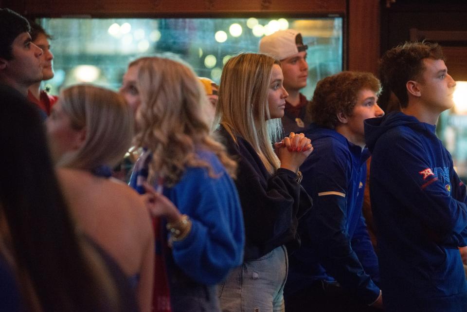 Kansas football fans keep their eyes glued to the screens inside Logie’s on Mass  in Lawrence as the Jayhawks battle Arkansas in the Liberty Bowl in Memphis.