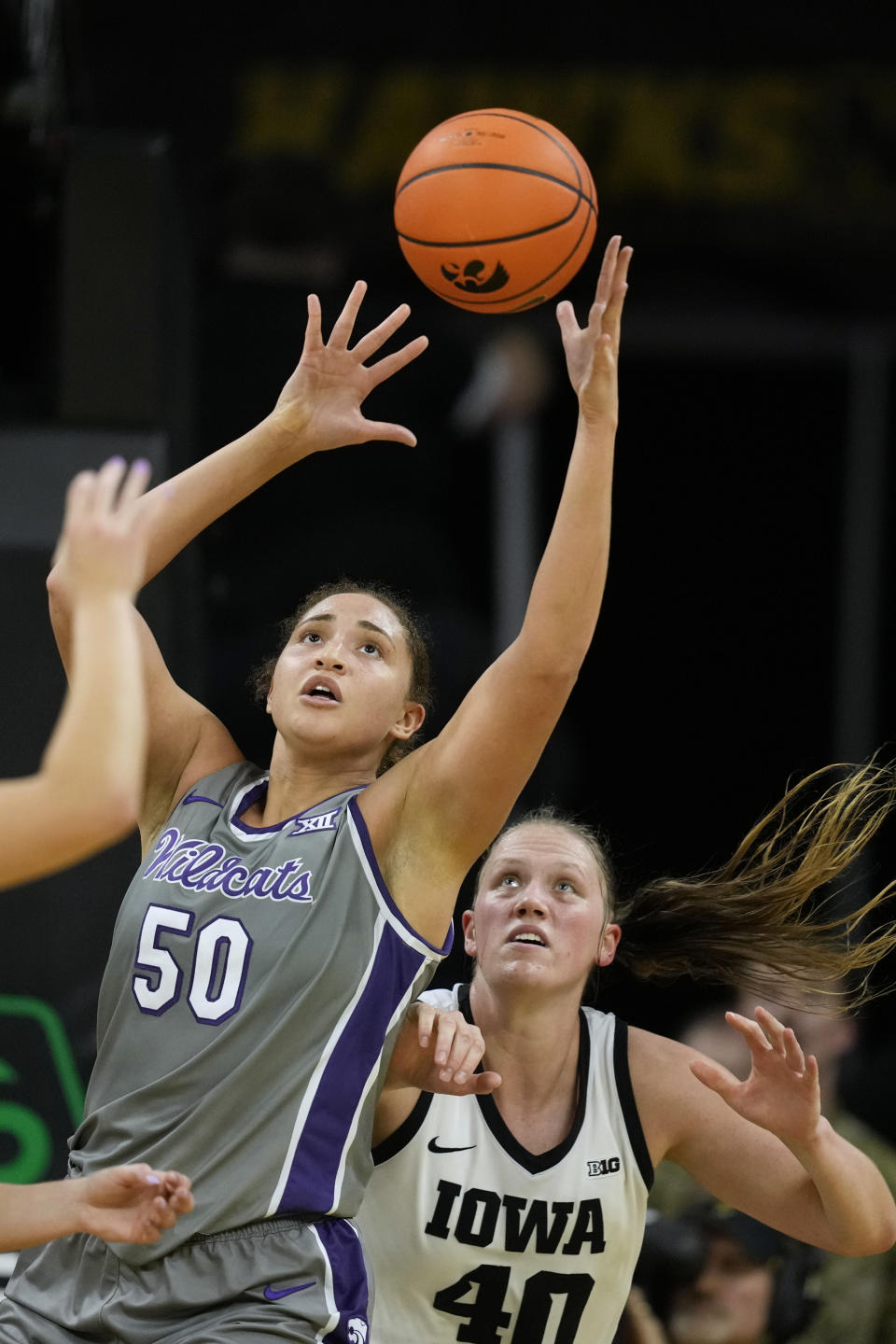 Kansas State center Ayoka Lee (50) grabs a rebound over Iowa center Sharon Goodman (40) during the second half of an NCAA college basketball game, Thursday, Nov. 16, 2023, in Iowa City, Iowa. Kansas State won 65-58. (AP Photo/Charlie Neibergall)