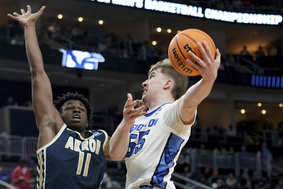 Creighton's Baylor Scheierman (55) drives against Akron's Sammy Hunter (11) during the second half of a college basketball game in the first round of the NCAA men's tournament Thursday, March 21, 2024, in Pittsburgh. (AP Photo/Matt Freed)