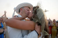 <p>Burning Man participant Dustin Smith kisses his wife Rebecca Wyatt as they are married in the middle of the desert during the 4th day of the annual Burning Man arts and music festival in the Black Rock Desert of Nevada, Aug. 31, 2017. (Photo: Jim Bourg/Reuters) </p>