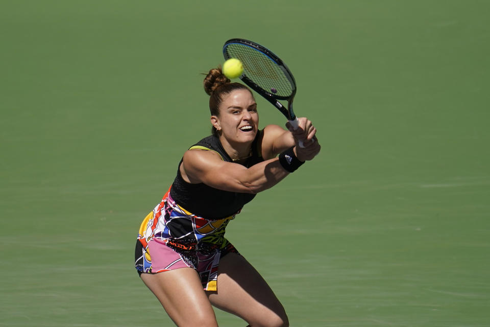 Maria Sakkari, of Greece, returns a shot to Iga Swiatek, of Poland, during the women's singles finals at the BNP Paribas Open tennis tournament Sunday, March 20, 2022, in Indian Wells, Calif. (AP Photo/Marcio Jose Sanchez)