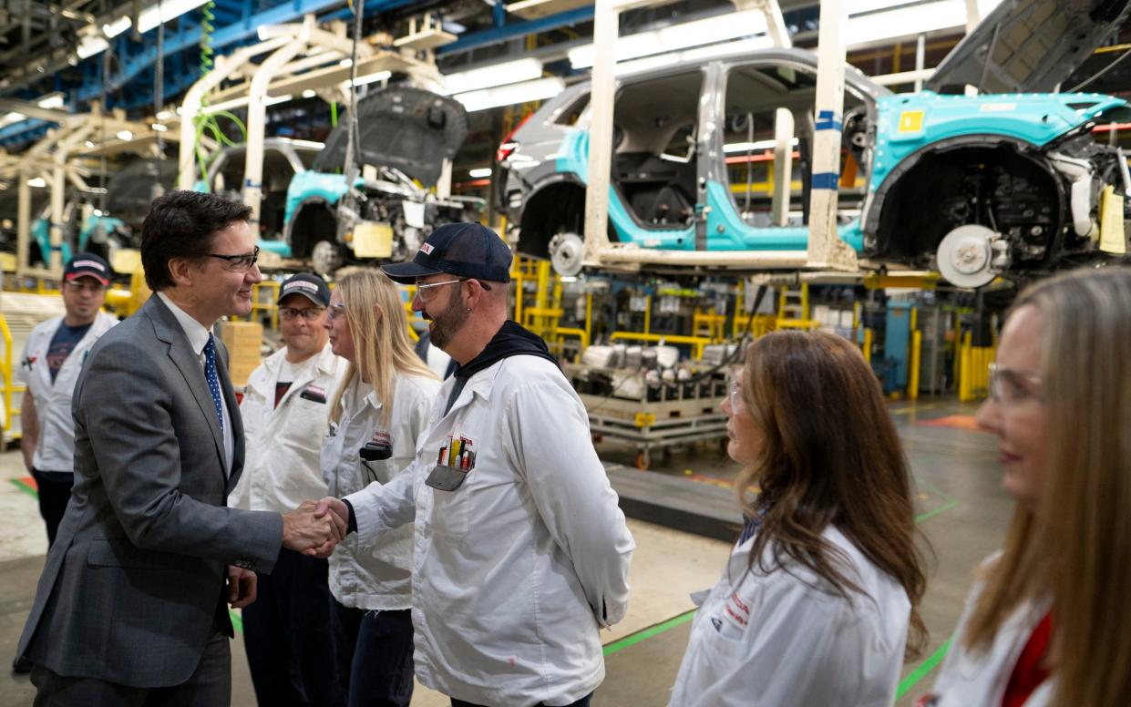 Canadian Prime Minister Justin Trudeau greets employees on the Honda CRV assembly line