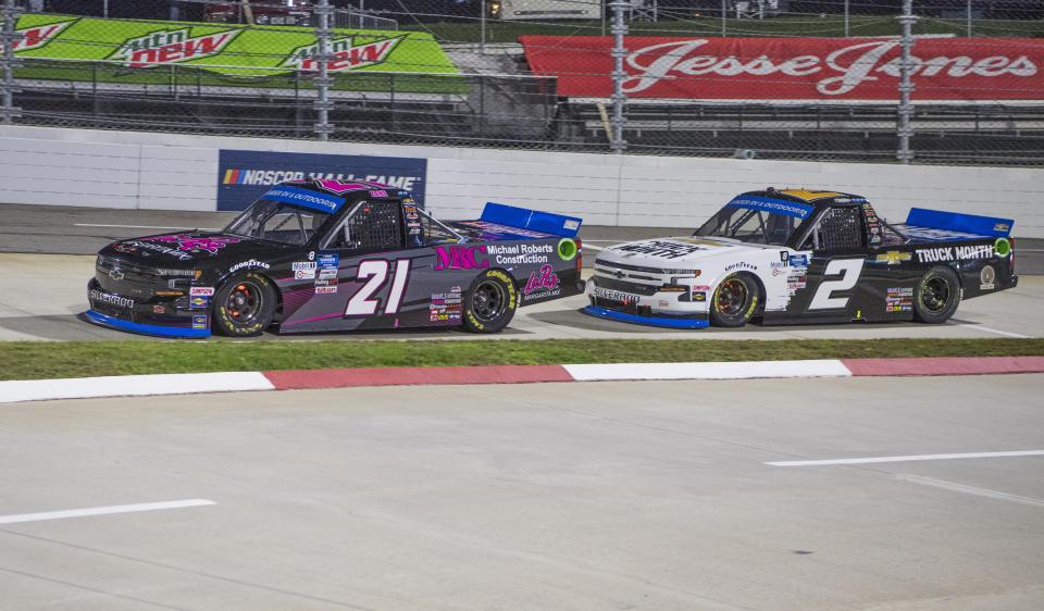 Zane Smith, left, and Sheldon Creed run in front early in the NASCAR Truck Series auto race at Martinsville Speedway in Martinsville, Va., Friday, Oct. 30, 2020. (AP Photo Lee Luther Jr.)