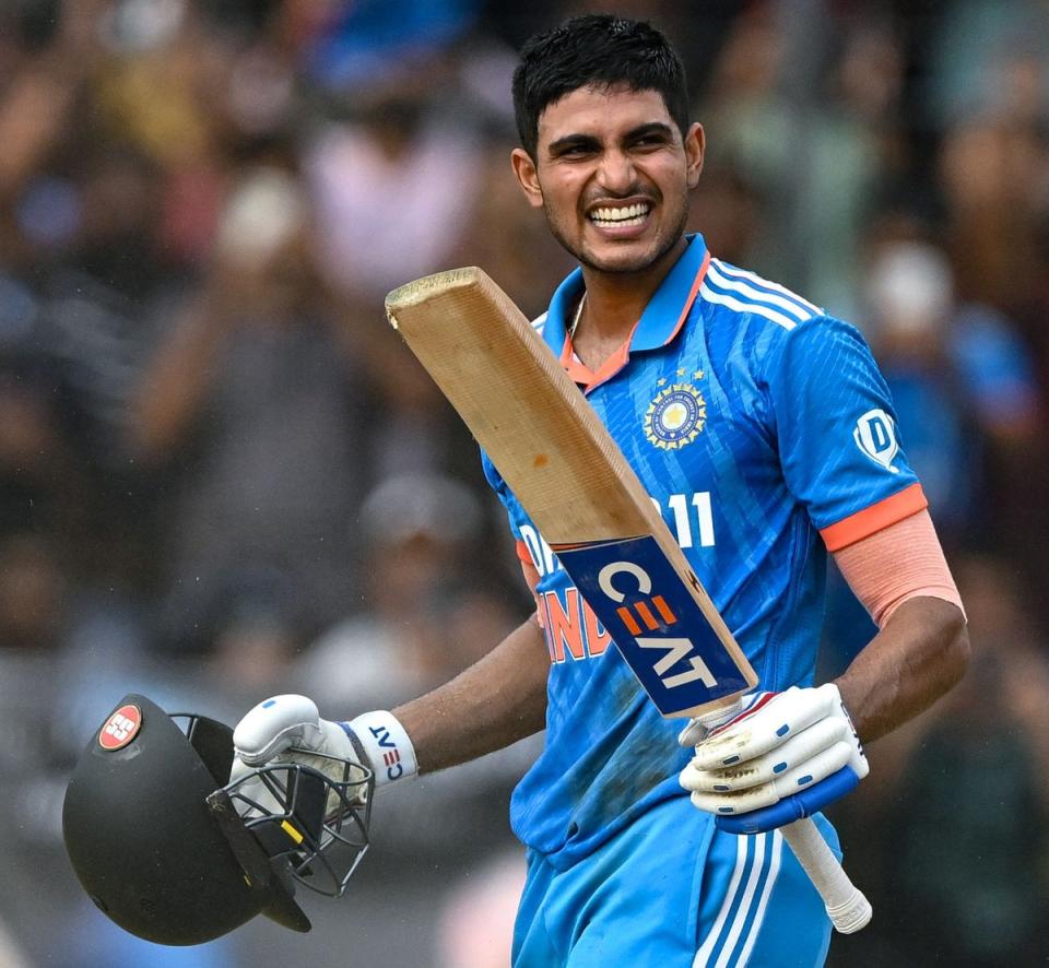 Shubman Gill celebrates after scoring a century (100 runs) during the second one-day international (ODI) cricket match between India and Australia at the Holkar Cricket Stadium in Indore on 24 September (AFP via Getty Images)