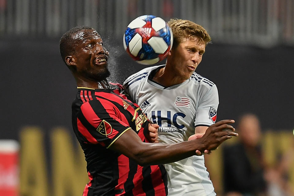 ATLANTA, GA  OCTOBER 19:  Atlanta's Florentin Pogba (4) and New England's Scott Caldwell (6) fight for a header during the MLS playoff match between the New England Revolution and Atlanta United FC on October 19th, 2019 at Mercedes-Benz Stadium in Atlanta, GA.  (Photo by Rich von Biberstein/Icon Sportswire via Getty Images)