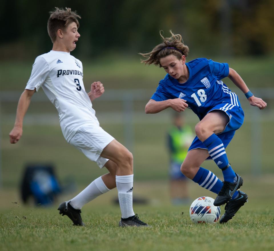 Memorial’s Ivan Bennett (18) is defended by Providence’s Luke Richards (3) during the Memorial Tigers vs Providence Pioneers for the IHSAA 2A Boy’s Regional Championship game at Gwaltney Sports Complex in Washington, Ind., Saturday afternoon, Oct. 15, 2022. 