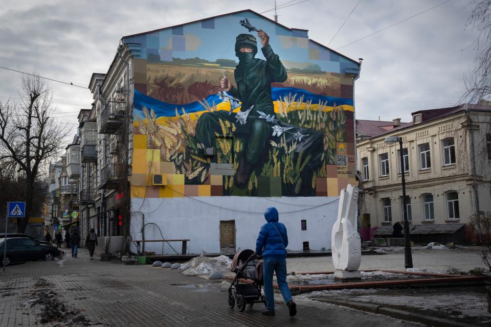 A mural depicts a 19-year old soldier from Ukraine's National Guard, Roman Holomba, who shot down seven Russian jets and a missile with an Igla portable anti-aircraft missile system, in Kyiv, Ukraine, Friday, Jan. 19, 2024.