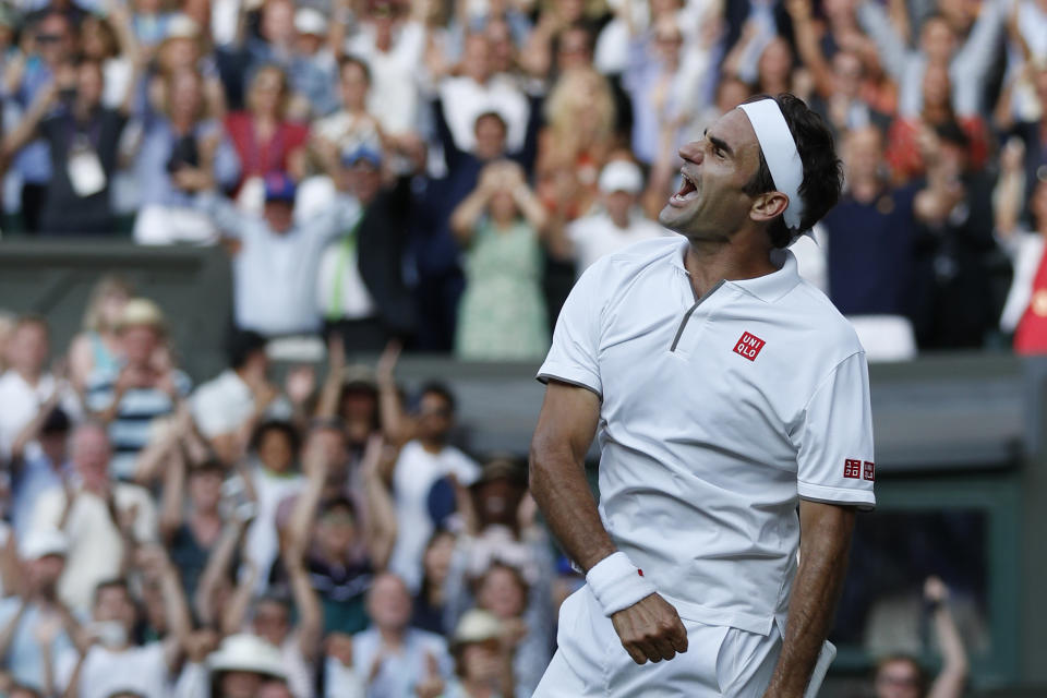 Switzerland's Roger Federer celebrates after beating Spain's Rafael Nadal in a Men's singles semifinal match on day eleven of the Wimbledon Tennis Championships in London, Friday, July 12, 2019. (Adrian Dennis/Pool Photo via AP)