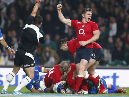 Owen Farrell celebrates as Mike Brown of England scores a try against Samoa during their international rugby test match at Twickenham in London, November 22, 2014. REUTERS/Andrew Winning