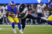 Los Angeles Rams quarterback John Wolford (13) is tackled by Houston Texans defensive end Demone Harris during the first half of a preseason NFL football game Friday, Aug. 19, 2022, in Inglewood, Calif. (AP Photo/Ashley Landis)