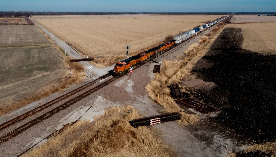 In late November, a freight train is seen traveling through the crossing near Mendon, Missouri, where a June crash killed four people and injured more than 150. The crossing is still closed.