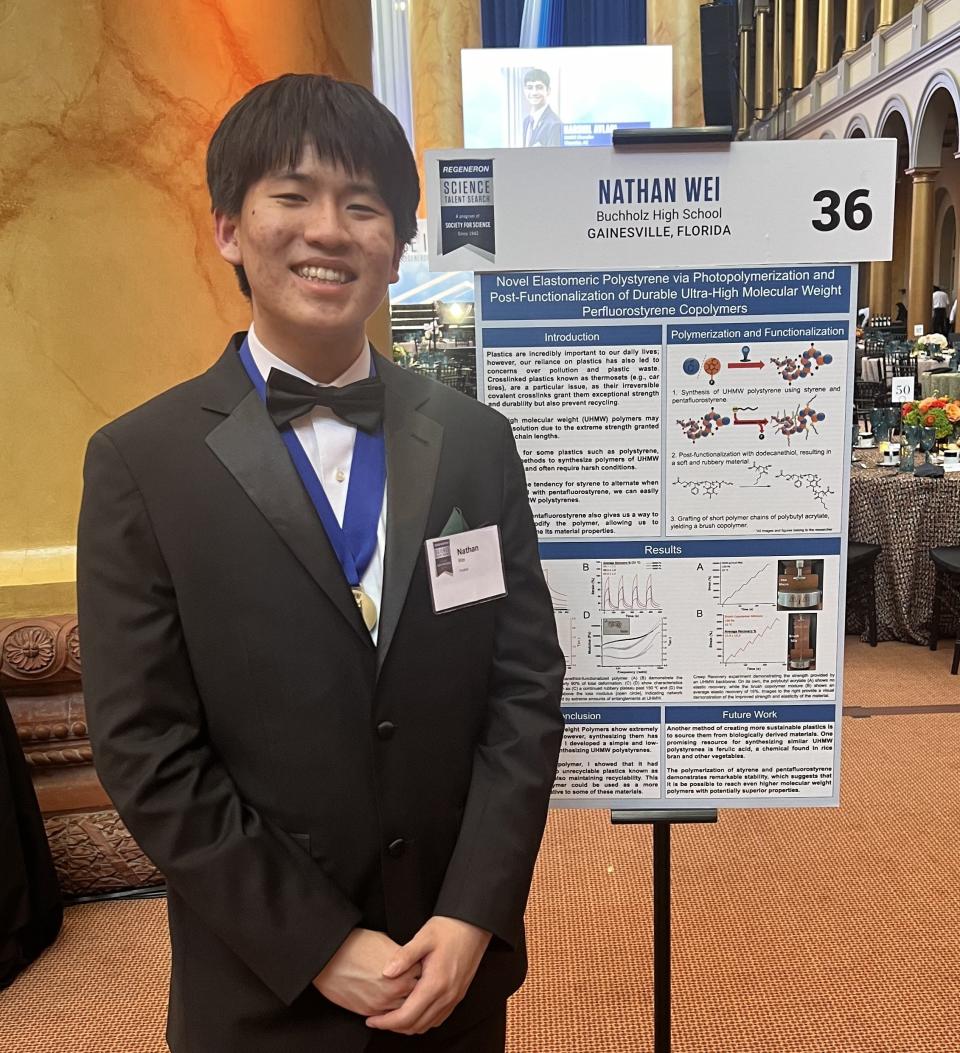 Nathan Wei, Buchholz High senior, stands next to a board detailing his research project which placed fourth in the Regeneron Science Talent Search finals.