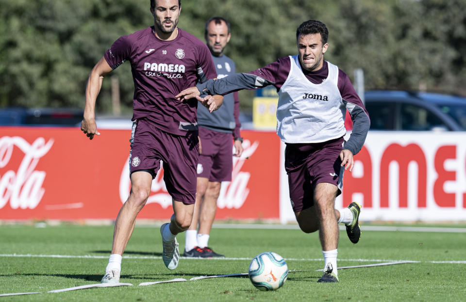 In this photo released by Villarreal Club de Futbol on Tuesday, Oct. 15, 2019, Giuseppe Rossi, right, duels for the ball during a training with Spanish club Villarreal, Spain. Italian-American striker Giuseppe Rossi, who played for the Italian national team before a series of injuries slowed his career, is back at Villarreal, the Spanish club where he thrived in his prime.(Villareal F.C via AP)