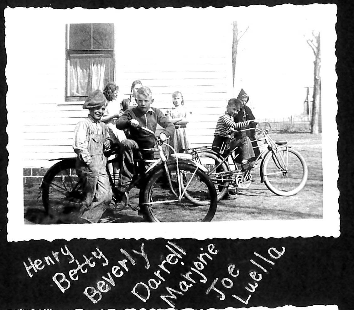 Children are pictured on bikes at Bell School in 1940.