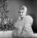 <p>The New York socialite defined shabby chic. Thanks to her extensive wardrobe of marabou feather-trimmed negligees, svelte sheath dresses, and glamorous chiffon evening gowns, she brought fashion to her rural country farm in every episode. </p>