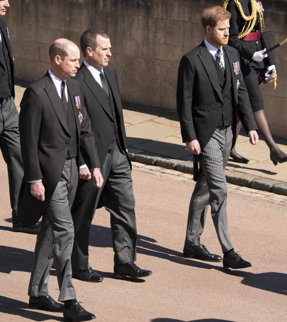 Prince William, Peter Phillips and Prince Harry follow Prince Philip's coffin