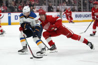 Detroit Red Wings defenseman Simon Edvinsson (3) defends St. Louis Blues left wing Nathan Walker (26) in the third period of an NHL hockey game Thursday, March 23, 2023, in Detroit. (AP Photo/Paul Sancya)