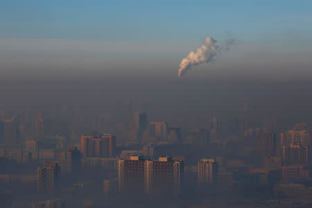 Emissions from a power plant chimney rise over Ulaanbaatar, Mongolia January 13, 2017. REUTERS/B. Rentsendorj