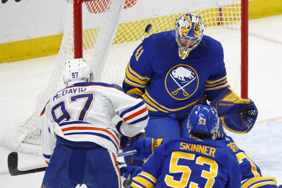 Edmonton Oilers center Connor McDavid (97) puts the puck past Buffalo Sabres goaltender Craig Anderson (41) during the third period of an NHL hockey game, Monday, March 6, 2023, in Buffalo, N.Y. (AP Photo/Jeffrey T. Barnes)