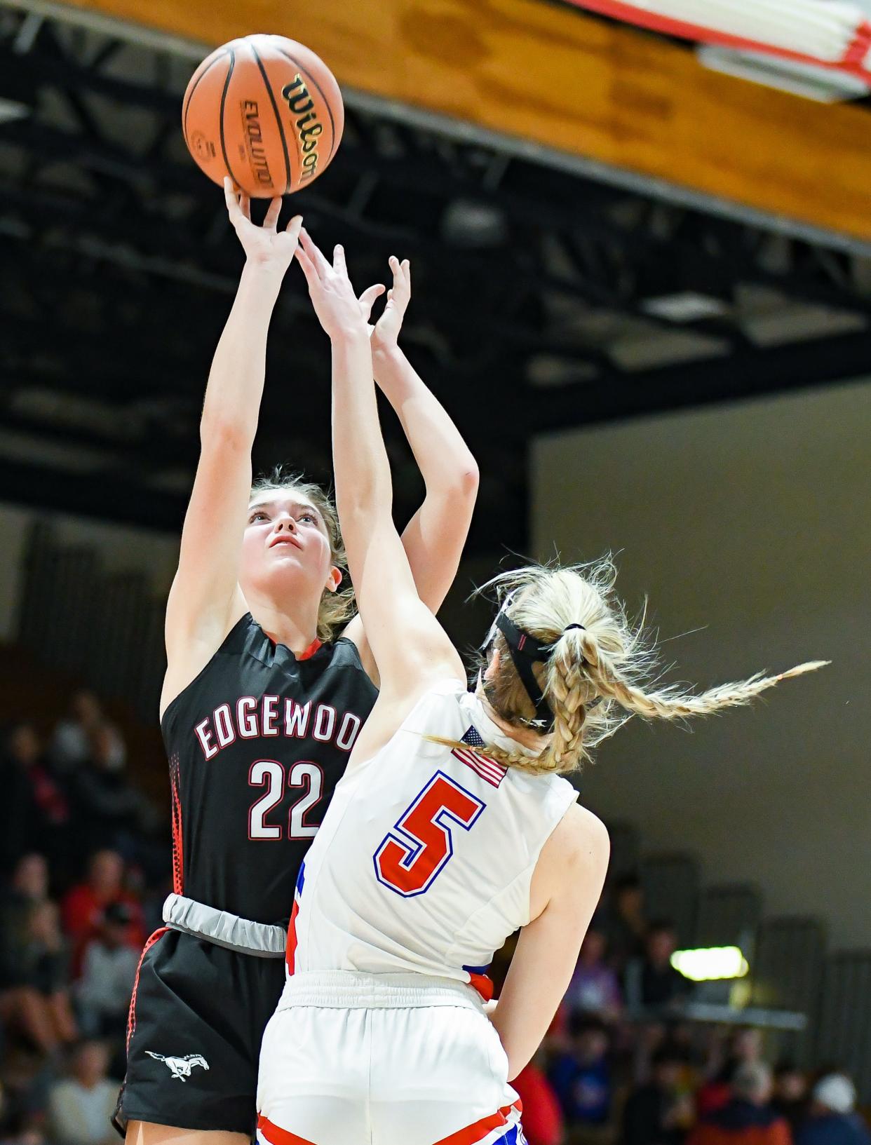 Edgewood’s Macey Crider (22) attempts a shot over Owen Valley’s Mallory Owen (5) during their game at Owen Valley on Friday, Jan. 12, 2024.