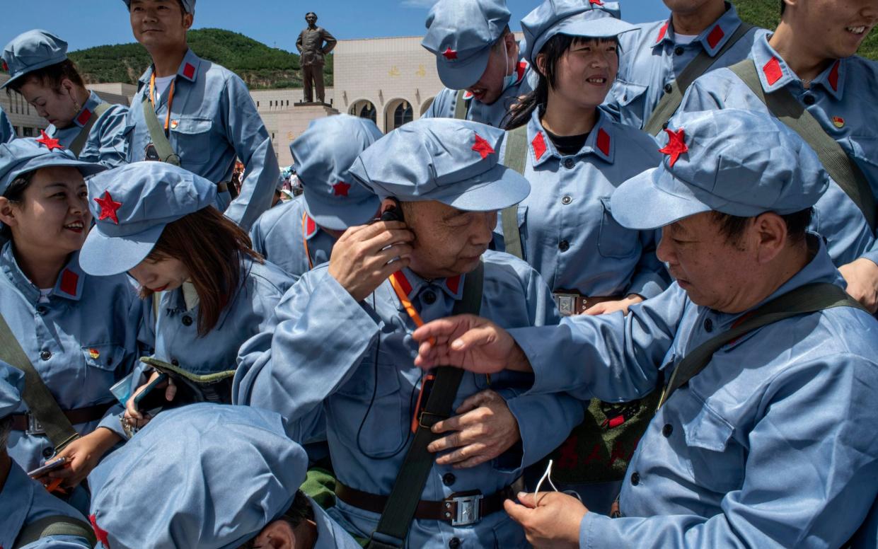 Tourists in Red Army costumes organize for a group photo at the Revolutionary Memorial Hall in Yan'an - Gilles Sabrieˆ/The New York Times/Redux/eyevine