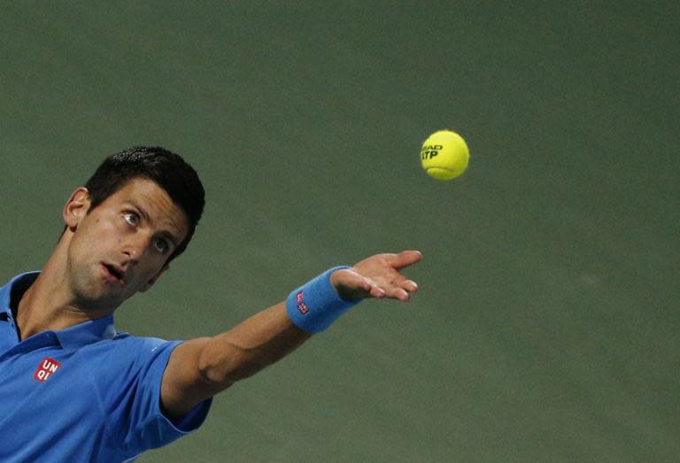 World number one tennis player Novak Djokovic of Serbia serves the ball to Andrey Golubev of Kazakhstan during their match at the ATP Dubai Duty Free Tennis Championships February 25, 2015 in Dubai