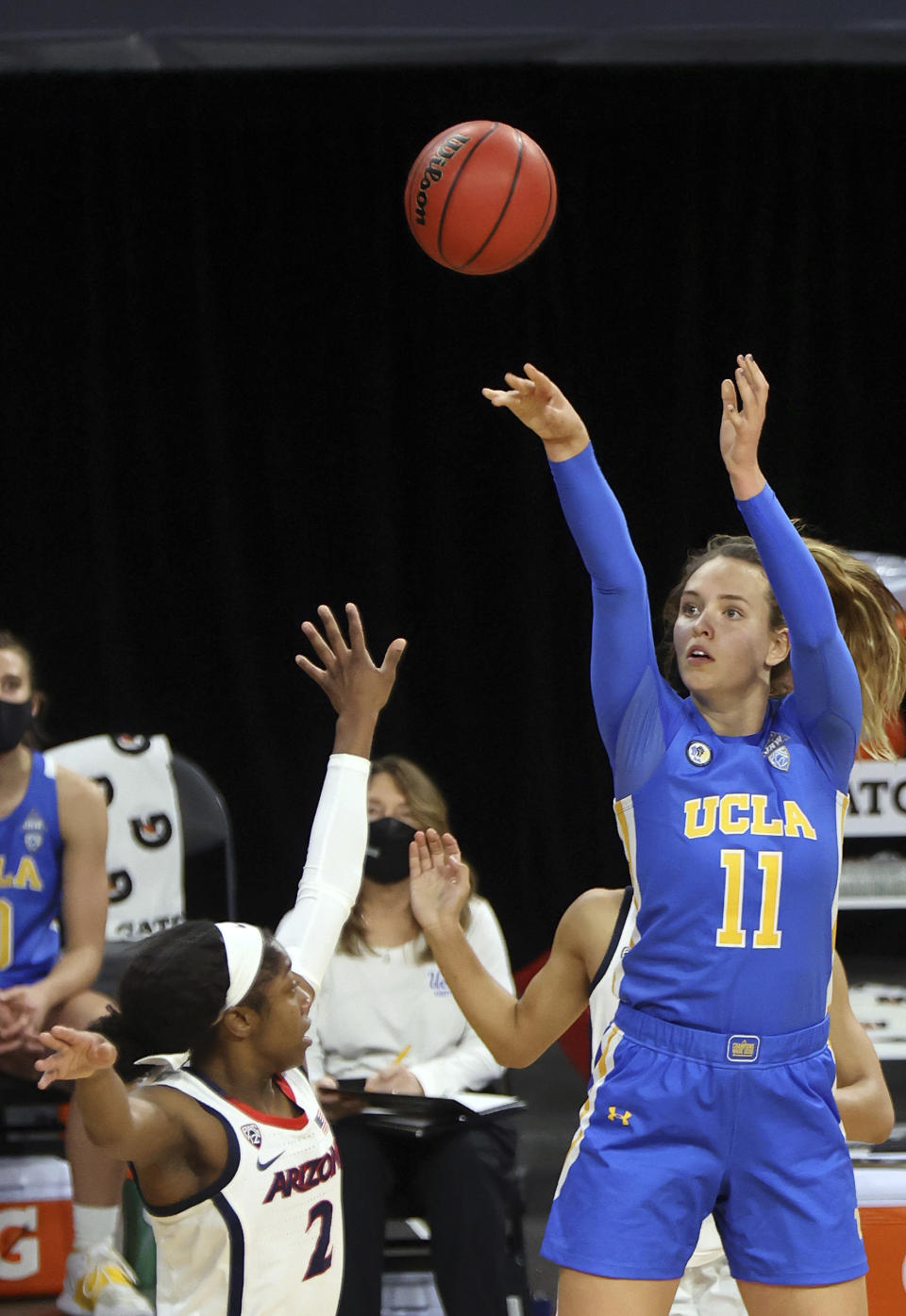 UCLA forward Emily Bessoir (11) shoots as Arizona guard Aari McDonald (2) defends during the second half of an NCAA college basketball game in the semifinals of the Pac-12 women's tournament Friday, March 5, 2021, in Las Vegas. (AP Photo/Isaac Brekken)