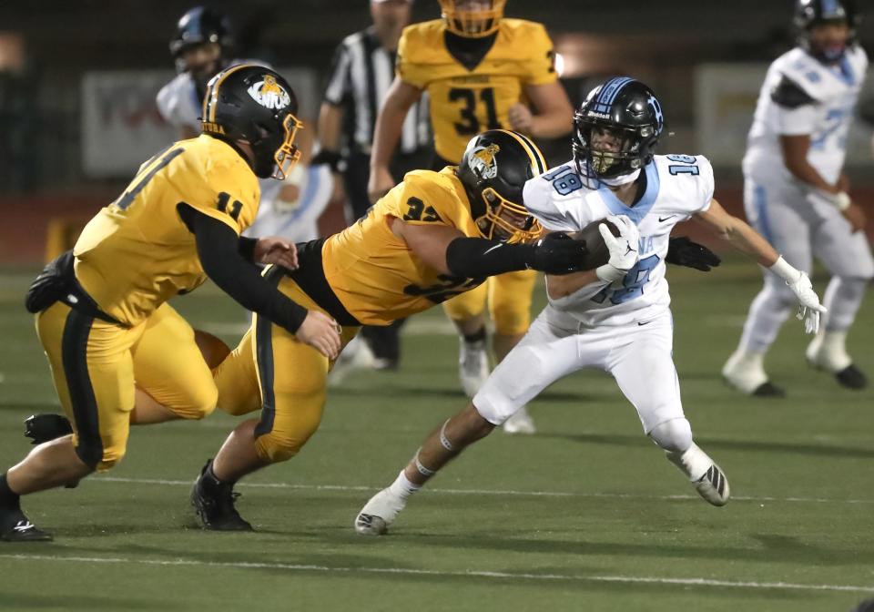 Buena's Aaron Cesario tries to shake free of the Ventura defense during the teams' rivalry game on Oct. 13.