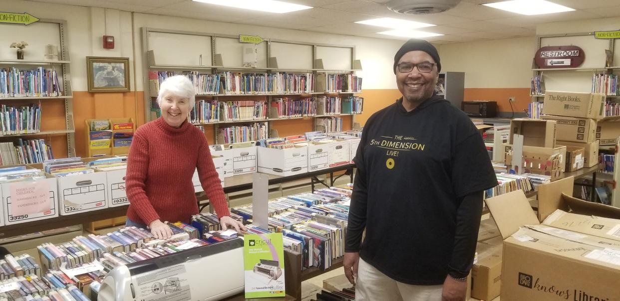 Betty Wilkin and Scott Gregory prepare for the Wooster Friends of the Library spring book sale set to open March 24.