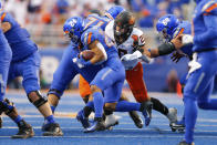 Boise State running back George Holani (24) is stopped by Oklahoma State linebacker Malcolm Rodriguez (20) during the first half of an NCAA college football game Saturday, Sept. 18, 2021, in Boise, Idaho. (AP Photo/Steve Conner)