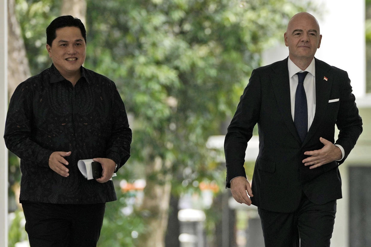 FILE - FIFA President Gianni Infantino, right, walks with Minister for State Owned Enterprises Erick Thohir upon arrival for a meeting with Indonesian President Joko Widodo at Merdeka Palace in Jakarta, Indonesia, Tuesday, Oct. 18, 2022. Indonesian soccer federation leader Erick Thohir says it now supports Saudi Arabia's bid to host the 2034 World Cup. (AP Photo/Achmad Ibrahim, File)