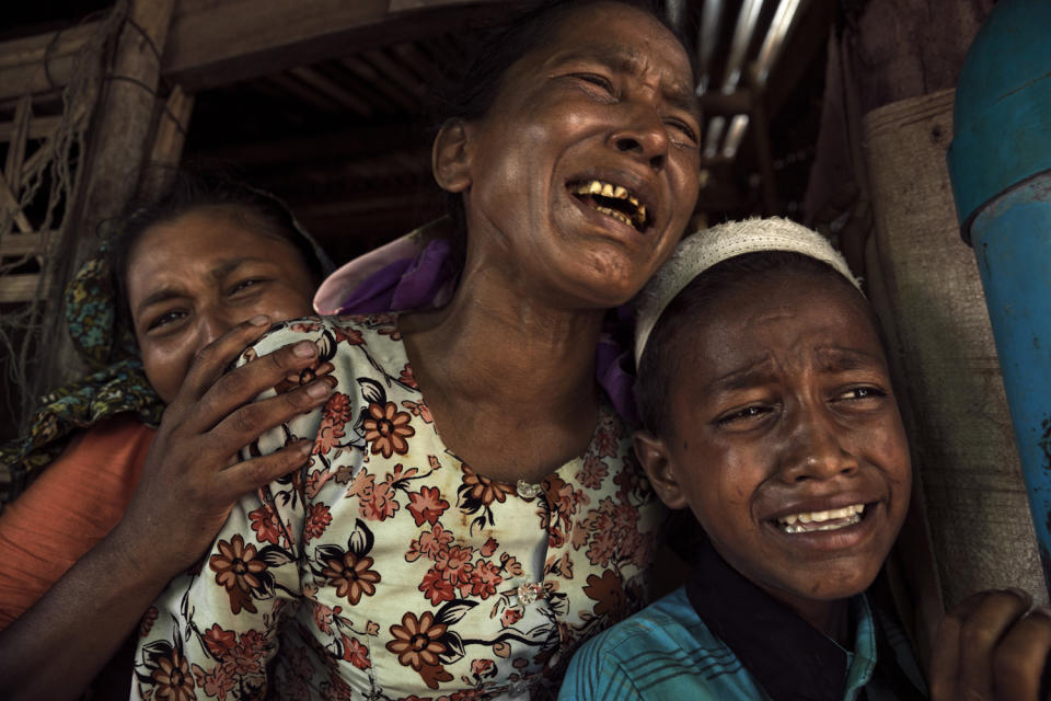 Relatives weep at the funeral of a woman who died at 35 of a stomach disease; she left five children behind.