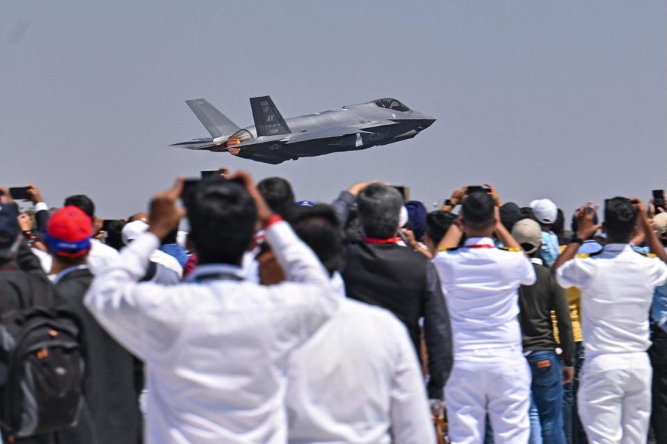 Spectators watch as a US Air Force’s (USAF) fifth-generation supersonic multirole F-35 fighter jet flies past during a flying display on the second day of the 14th edition of Aero India 2023 at the Yelahanka Air Force Station in Bengaluru (AFP via Getty Images)