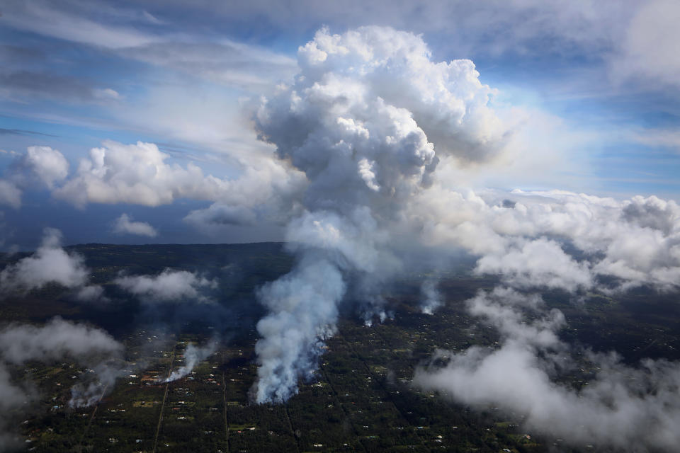 A plume of gas mixed with smoke from fires caused by lava rises amid clouds in Leilani Estates&nbsp;on Sunday.
