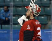 Ice Hockey - Pyeongchang 2018 Winter Olympics - Man’s Quarterfinal Match - Canada v Finland - Gangneung Hockey Centre, Gangneung, South Korea - February 21, 2018 - Goalie Kevin Poulin of Canada reacts during a break in action. REUTERS/David W Cerny