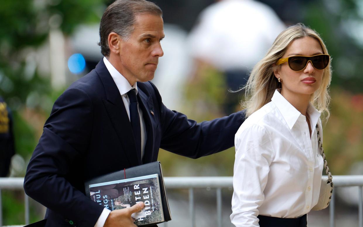 Hunter Biden and his wife Melissa Cohen Biden during his trial. At one point, a prosecutor held up Biden's silver MacBook Pro for jurors to see
