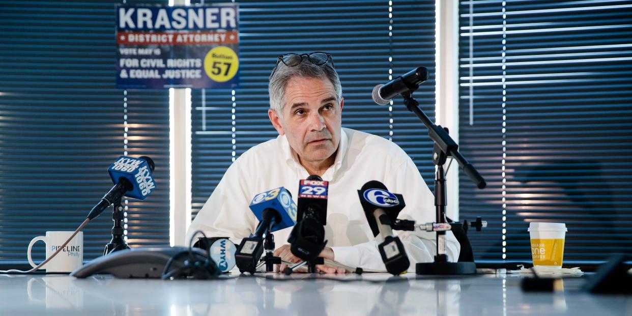Krasner with microphones in front of him