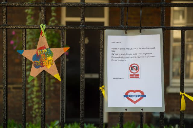 A sign asks visitors not to take photos of Grenfell Tower, in west London, with the area expecting a huge number of people during the Notting Hill Carnival