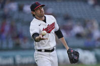 Cleveland Indians starting pitcher Shane Bieber tosses the ball to first base to get Chicago Cubs' Joc Pederson out in the third inning of a baseball game, Tuesday, May 11, 2021, in Cleveland. (AP Photo/Tony Dejak)