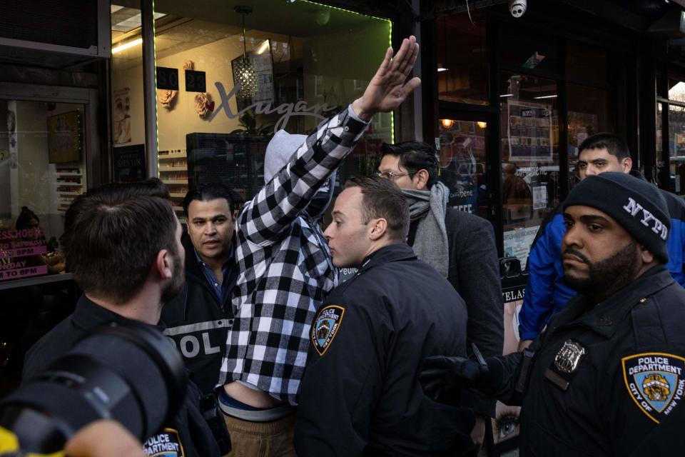 A man gives a Nazi salute during a protest against drag story hour outside the Queens Public Library on Dec. 29, 2022, in New York.