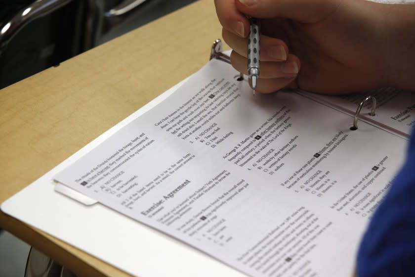 In this photo taken Jan. 17, 2016, a student looks at questions during a college test preparation class at Holton Arms School. The current version of the SAT college entrance exam is having its final run, when thousands of students nationwide will sit, squirm or stress through the nearly four-hour reading, writing and math test. A new revamped version debuts in March. (AP Photo/Alex Brandon)
