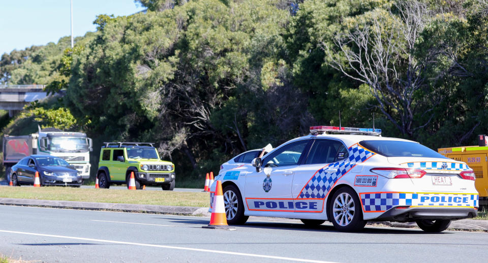 Australian Defence Force (ADF) personnel and Queensland Police process commuters crossing the Queensland-New South Wales state border at Coolangatta, QLD, Wednesday, August 25, 2021. Source: AAP