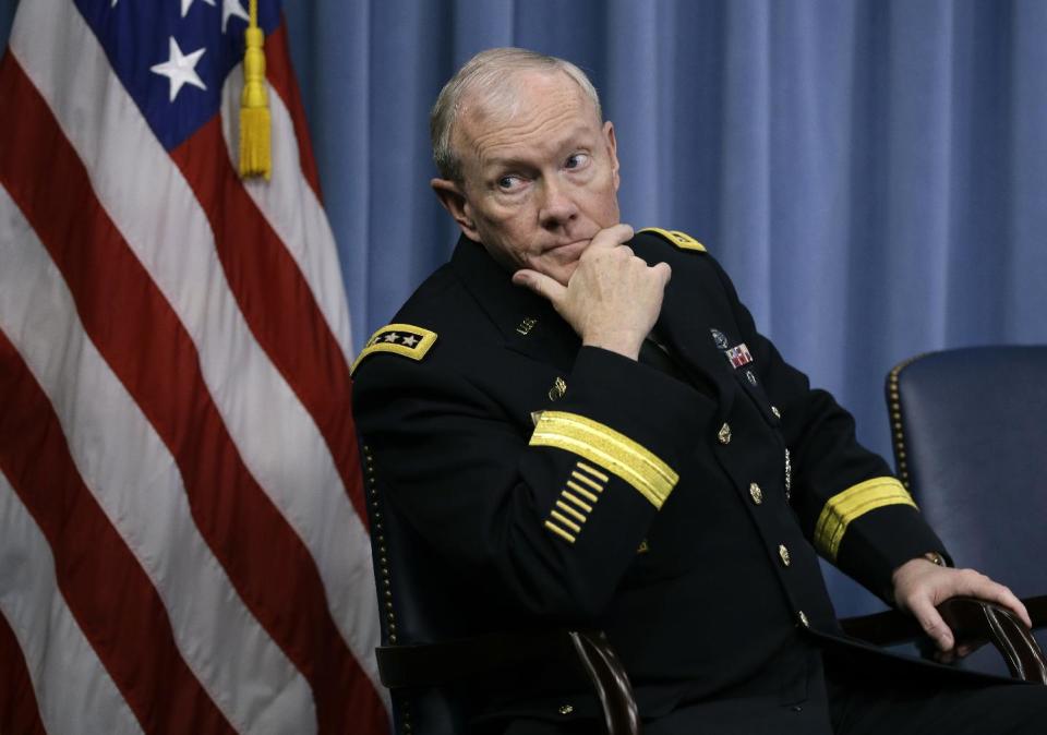 Joint Chiefs Chairman Gen. Martin Dempsey listens as Defense Secretary Chuck Hagel briefs reporters at the Pentagon, Monday, Feb. 24, 2014, where he recommended shrinking the Army to its smallest size since the buildup to U.S. involvement in World War II in an effort to balance postwar defense needs with budget realities. (AP Photo/Carolyn Kaster)