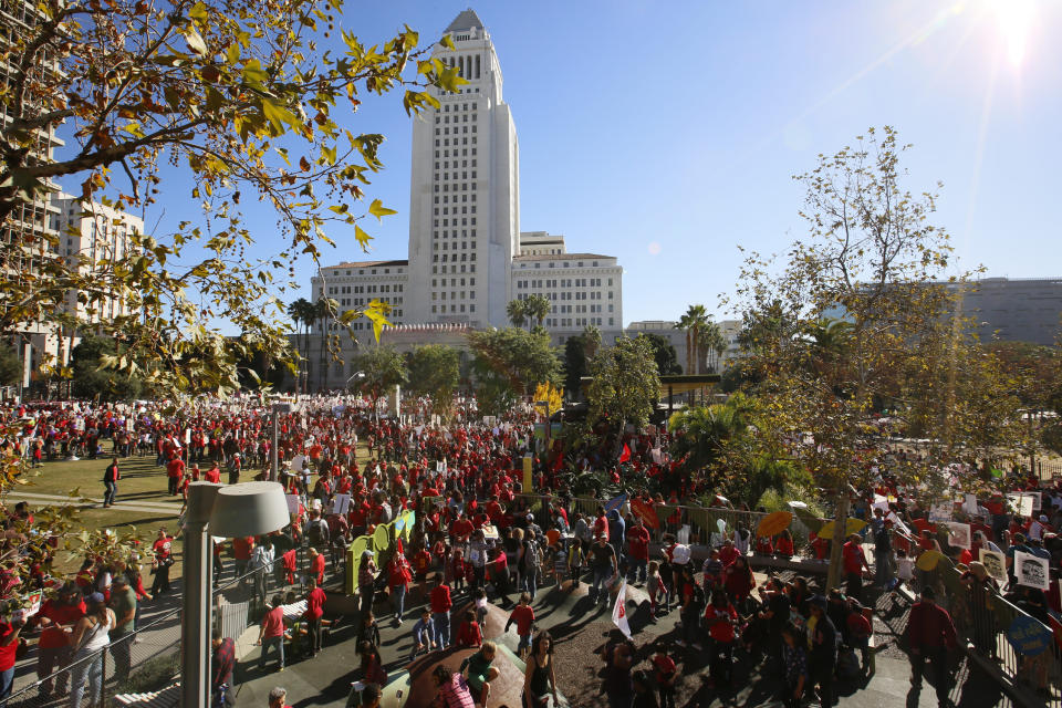 In this Saturday, Dec. 15, 2018, photo, thousands of teachers marched and rallied outside Los Angeles City Hall. Teachers in the nation's second-largest school district will go on strike next month if there's no settlement of its long-running contract dispute, union leaders said Wednesday, Dec. 19. The announcement by United Teachers Los Angeles threatens the first strike against the Los Angeles Unified School District in nearly 30 years and follows about 20 months of negotiations. (AP Photo/Damian Dovarganes)