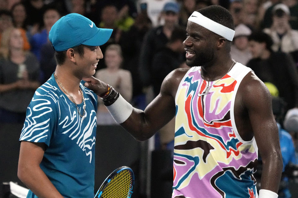 Shang Juncheng, left, of China congratulates Frances Tiafoe of the U.S. following their second round match at the Australian Open tennis championship in Melbourne, Australia, Wednesday, Jan. 18, 2023. (AP Photo/Aaron Favila)