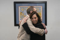 Rabbi Charlie Cytron-Walker, left, get a hug from Anna Salton Eisen at Congregation Beth Israel in Colleyville, Texas, Thursday, April 7, 2022. Three months after an armed captor took hostages at the Texas synagogue during a 10-hour standoff that ended with the escape of the hostages and fatal shooting of the gunman by the FBI, the house of worship is reopening. (AP Photo/LM Otero)