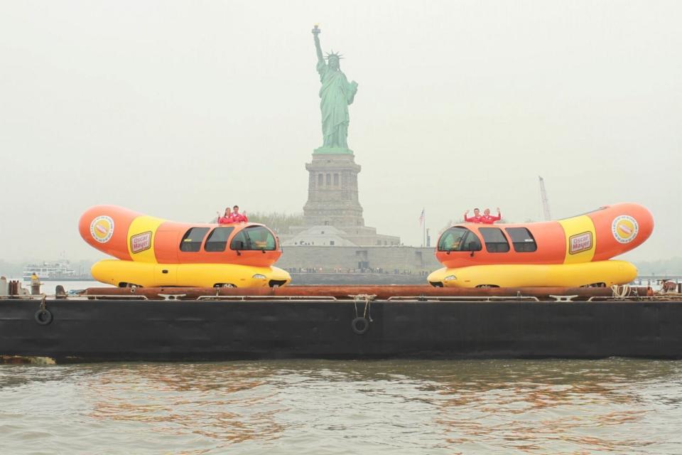 PHOTO: Two of the Wienermobiles in front of the Statue of Liberty. (Oscar Mayer)